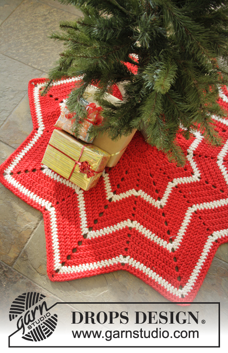 Under the Christmas Tree / DROPS Extra 0-1050 - Dywanik na szydełku w kształcie gwiazdy, w paski i wzorem zygzakowym, z włóczki DROPS Snow. Temat: Boże Narodzenie.