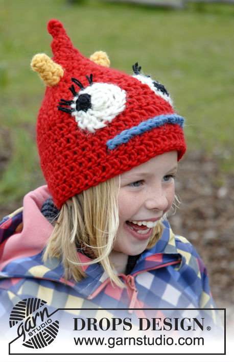 DROPS Extra 0-928 - Cappello per bambini a forma di mostro lavorato all'uncinetto in DROPS Eskimp. Il cappello è lavorato con corna, occhi e bocca. Taglie: 3 - 14 anni.