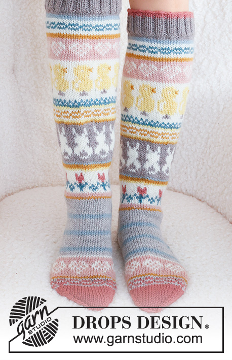 Easter Dance Socks / DROPS 229-35 - Knitted socks in DROPS Karisma. The piece is worked top down in stockinette stitch, with multi-colored pattern and heart, Easter chick, Easter bunny and flower. Sizes 35 – 43 = US 4 1/2 - 12 1/2.. Theme: Easter.
