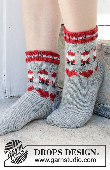 Santa Time Socks / DROPS 234-65 - Kötött Drops zokni DROPS Karisma fonalból. A darabot fentről lefelé kötjük, színes, télapó és szív mintával 35 - 43 -as méretben Téma: Karácsony