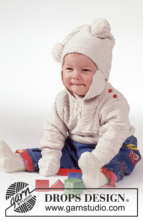Winter Bunny / DROPS Baby 1-2 - Drops Aran trui en muts met pompoms, sokken en wanten van “Safran”. Maat 3 t/m 24 maanden.