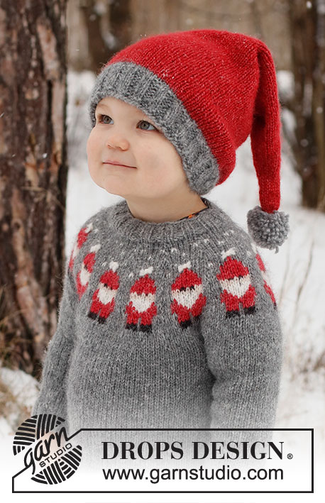 Merry Santas / DROPS Children 41-1 - Dziecięcy sweter / świąteczny sweter i czapka / świąteczna czapka na drutach z włóczki DROPS Air. Sweter jest przerabiany od góry do dołu, z zaokrąglonym karczkiem i żakardem w Mikołaje. Czapka jest przerabiana na okrągło, od dołu do góry. Od 2 do 14 lat. Temat: Boże Narodzenie.